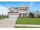 Beautiful two-story house featuring a well-manicured lawn and a two-car garage with a long driveway at 1783 Ballard Rd # Apex Georgian, Fuquay Varina, NC 27526