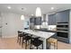 Bright eat-in kitchen featuring modern appliances, quartz counters, an island with seating, and stylish pendant lighting at 1783 Ballard Rd # Apex Georgian, Fuquay Varina, NC 27526