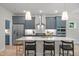 Bright kitchen features modern appliances, quartz counters, an island with seating, and stylish pendant lighting at 1783 Ballard Rd # Apex Georgian, Fuquay Varina, NC 27526
