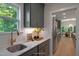 Kitchenette featuring custom cabinets, sink, quartz countertops and designer fixtures with view to dining and kitchen at 1783 Ballard Rd # Apex Georgian, Fuquay Varina, NC 27526