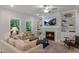 Cozy living room featuring a fireplace with built-ins, comfortable seating, and lots of natural light at 1783 Ballard Rd # Apex Georgian, Fuquay Varina, NC 27526