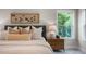 Bright main bedroom featuring large window, stylish decor, and comfortable bed with decorative pillows at 1783 Ballard Rd # Apex Georgian, Fuquay Varina, NC 27526