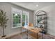 Inviting home office with ample natural light, a wooden desk, stylish shelving, and tranquil garden views at 1783 Ballard Rd # Apex Georgian, Fuquay Varina, NC 27526