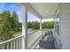 Relaxing porch with comfortable seating overlooking a peaceful, wooded landscape at 1783 Ballard Rd # Apex Georgian, Fuquay Varina, NC 27526