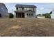 Back exterior elevation showing backyard with patio; home features double-paned windows at 1803 Ballard Rd # Holly Craftsman, Fuquay Varina, NC 27526