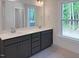 Bathroom with a double sink vanity with quartz countertop, undermount sinks and a large window at 1803 Ballard Rd # Holly Craftsman, Fuquay Varina, NC 27526