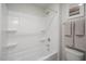 A clean bathroom with a bathtub-shower combination, white tiles, and a storage caddy with bath accessories at 1803 Ballard Rd # Holly Craftsman, Fuquay Varina, NC 27526