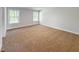 Spacious bedroom with neutral walls, carpet flooring, and two bright windows at 1803 Ballard Rd # Holly Craftsman, Fuquay Varina, NC 27526