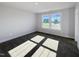 Sun-drenched bedroom with carpet flooring, neutral walls and two windows at 1803 Ballard Rd # Holly Craftsman, Fuquay Varina, NC 27526