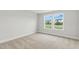 Inviting bedroom with plush carpet and window bringing natural light into the space at 1803 Ballard Rd # Holly Craftsman, Fuquay Varina, NC 27526