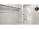 A closet with a wooden rod to hang clothes with an open door at the side at 1803 Ballard Rd # Holly Craftsman, Fuquay Varina, NC 27526