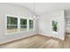 Bright dining area featuring a chandelier, large windows with backyard view and vinyl flooring at 1803 Ballard Rd # Holly Craftsman, Fuquay Varina, NC 27526