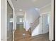 Welcoming foyer with wood-look tile flooring, staircase, and views into other rooms at 1803 Ballard Rd # Holly Craftsman, Fuquay Varina, NC 27526