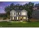 Charming two-story home at dusk with gray siding, black shutters, and a well-manicured lawn at 1803 Ballard Rd # Holly Craftsman, Fuquay Varina, NC 27526