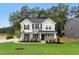 Charming two-story home with gray siding, black shutters, and a well-manicured lawn at 1803 Ballard Rd # Holly Craftsman, Fuquay Varina, NC 27526