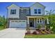Charming two-story home featuring a welcoming entrance, a two car garage and landscaped front yard at 1803 Ballard Rd # Holly Craftsman, Fuquay Varina, NC 27526