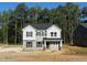 Two-story home with gray siding, black shutters, and a covered front porch on a tree-lined lot at 1803 Ballard Rd # Holly Craftsman, Fuquay Varina, NC 27526