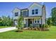 Charming two-story home featuring a welcoming entrance, a two car garage and landscaped front yard at 1803 Ballard Rd # Holly Craftsman, Fuquay Varina, NC 27526
