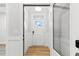 Bright foyer with white wainscoting, wood floors, and a glass paneled storm door at 1803 Ballard Rd # Holly Craftsman, Fuquay Varina, NC 27526