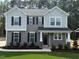 Charming two-story home with gray siding, black shutters, and a well-manicured lawn at 1803 Ballard Rd # Holly Craftsman, Fuquay Varina, NC 27526