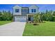 Inviting two-story home with a lush green lawn, landscaping, and a two car garage at 1803 Ballard Rd # Holly Craftsman, Fuquay Varina, NC 27526