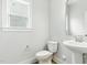 Half bathroom with white walls, white vanity, and laminate flooring at 1803 Ballard Rd # Holly Craftsman, Fuquay Varina, NC 27526