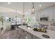 Bright, open-concept kitchen flows into the dining area, featuring pendant lighting and modern finishes at 1803 Ballard Rd # Holly Craftsman, Fuquay Varina, NC 27526