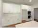 Bright white kitchen with stainless appliances, white subway tile backsplash and hardwood flooring at 1803 Ballard Rd # Holly Craftsman, Fuquay Varina, NC 27526