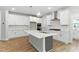Modern kitchen with white cabinets, stainless steel appliances, island, and subway tile backsplash at 1803 Ballard Rd # Holly Craftsman, Fuquay Varina, NC 27526