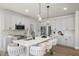 Bright kitchen featuring white cabinets, stainless steel appliances, and quartz countertops with stylish pendant lighting at 1803 Ballard Rd # Holly Craftsman, Fuquay Varina, NC 27526