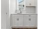 Bright laundry room featuring white cabinets, quartz countertops, and chrome hardware at 1803 Ballard Rd # Holly Craftsman, Fuquay Varina, NC 27526