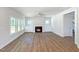Spacious living room with a fireplace, built-in cabinets, large windows, and wood-look flooring at 1803 Ballard Rd # Holly Craftsman, Fuquay Varina, NC 27526