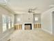 Spacious living room with a ceiling fan, a fireplace, and built-in cabinets at 1803 Ballard Rd # Holly Craftsman, Fuquay Varina, NC 27526