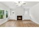 Bright living room with a fireplace, built-in shelves, and large windows at 1803 Ballard Rd # Holly Craftsman, Fuquay Varina, NC 27526