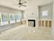 Bright living room featuring large windows, a fireplace, and built-in cabinets at 1803 Ballard Rd # Holly Craftsman, Fuquay Varina, NC 27526
