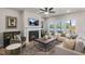 Comfortable living room with a cozy fireplace, plush seating, and plenty of natural light at 1803 Ballard Rd # Holly Craftsman, Fuquay Varina, NC 27526