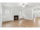 Bright living room with a fireplace, built-in shelves, wood look floors and a ceiling fan at 1803 Ballard Rd # Holly Craftsman, Fuquay Varina, NC 27526