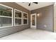 Covered patio featuring concrete flooring, brown siding, white trim, and entry door at 1803 Ballard Rd # Holly Craftsman, Fuquay Varina, NC 27526