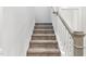 Carpeted staircase with white wood trim, leading to the upper level at 1803 Ballard Rd # Holly Craftsman, Fuquay Varina, NC 27526