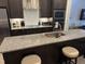 Kitchen island with granite countertop, bar seating, and pendant lighting at 1833 Fahey Dr, Apex, NC 27502