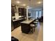 Modern kitchen with stainless steel appliances, dark cabinets, and a large center island at 1833 Fahey Dr, Apex, NC 27502