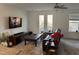 Bright living room with hardwood floors, a ceiling fan, and a view to the balcony at 1833 Fahey Dr, Apex, NC 27502