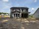 New home backyard featuring freshly turned dirt and a covered porch area at 1849 Ballard Rd # Holly Georgian, Fuquay Varina, NC 27526