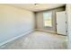 Bedroom with trim, one window and a door to the side at 1849 Ballard Rd # Holly Georgian, Fuquay Varina, NC 27526