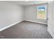 Neutral bedroom offers comfortable carpeting and a view from the bright window at 1849 Ballard Rd # Holly Georgian, Fuquay Varina, NC 27526