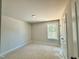 Neutral bedroom with a window and a door to the side at 1849 Ballard Rd # Holly Georgian, Fuquay Varina, NC 27526