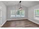 Bright dining room featuring hard surface floors, a modern light fixture, and lots of natural light at 1849 Ballard Rd # Holly Georgian, Fuquay Varina, NC 27526