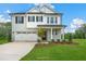 An exterior elevation showcasing the home's architectural design, including a two-car garage and well-manicured front lawn at 1849 Ballard Rd # Holly Georgian, Fuquay Varina, NC 27526