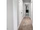 Hallway with carpet, white trim, and doors leading to other rooms in the home at 1849 Ballard Rd # Holly Georgian, Fuquay Varina, NC 27526