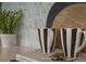 Close-up of stylish kitchen decor showcasing marble tile, striped mugs, and modern plant at 1849 Ballard Rd # Holly Georgian, Fuquay Varina, NC 27526